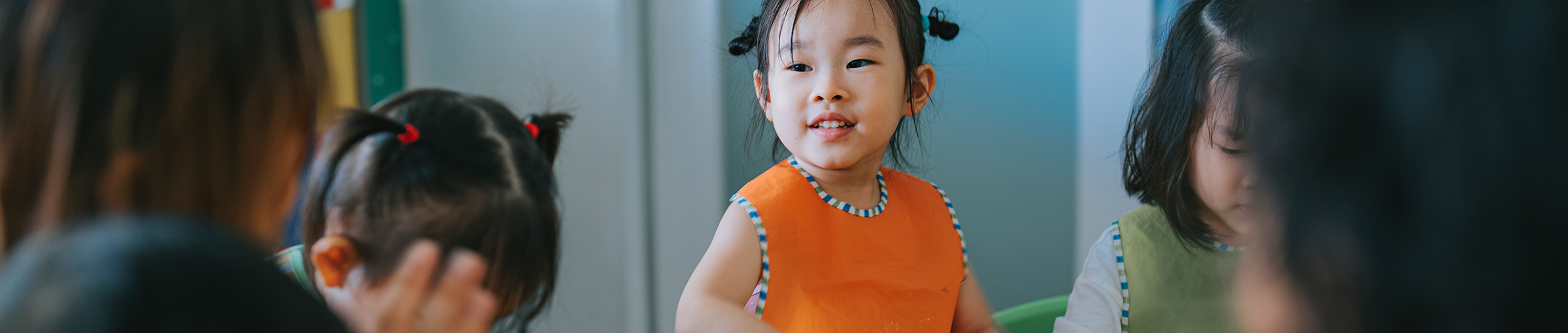 Image of asian girl with fluoro vest doing art