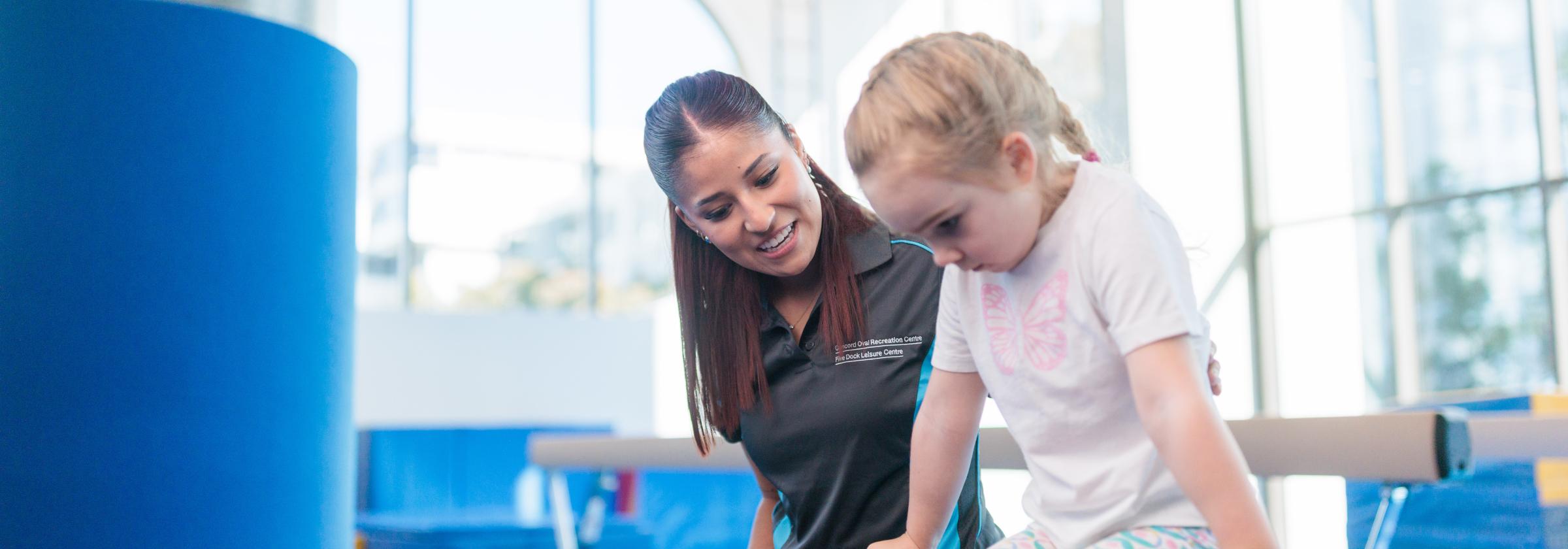 Gymnastics coach and child