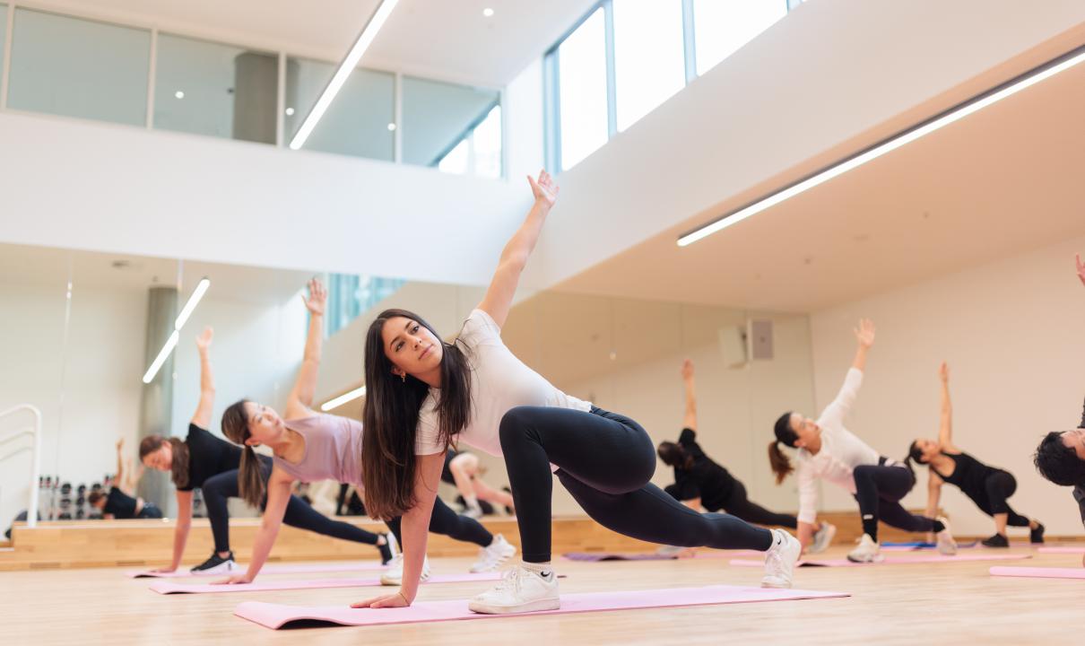 People stretching in yoga class