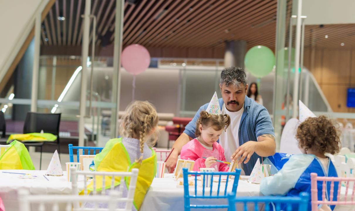 Guardian and children at a craft table