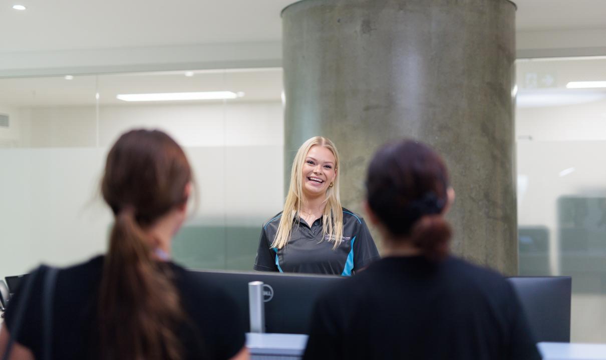 Customer service person smiling at people