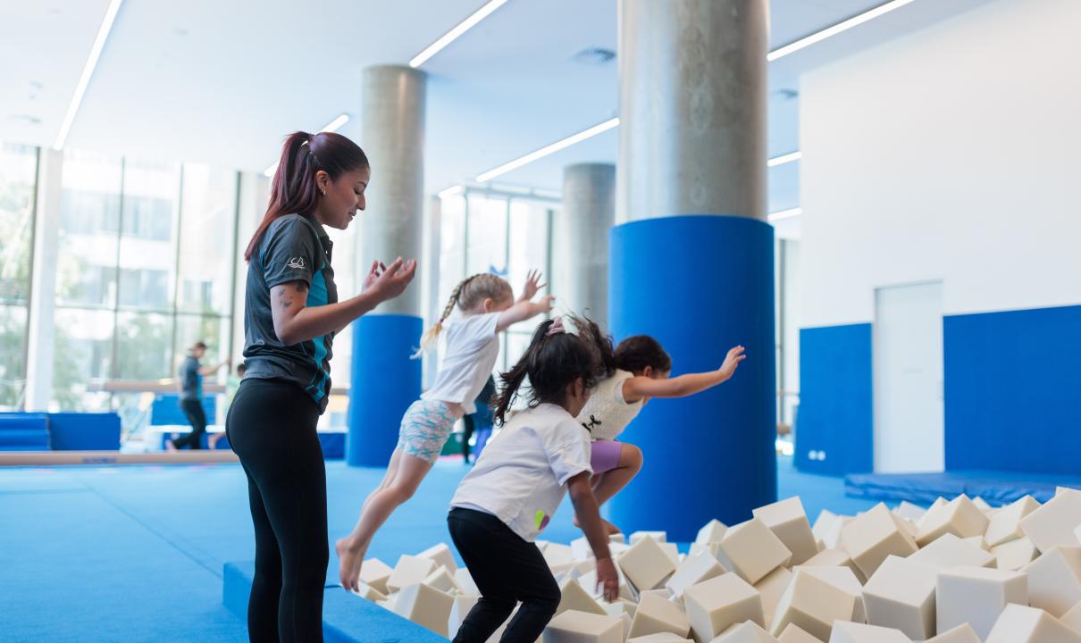 Kids jumping into the soft cube pit