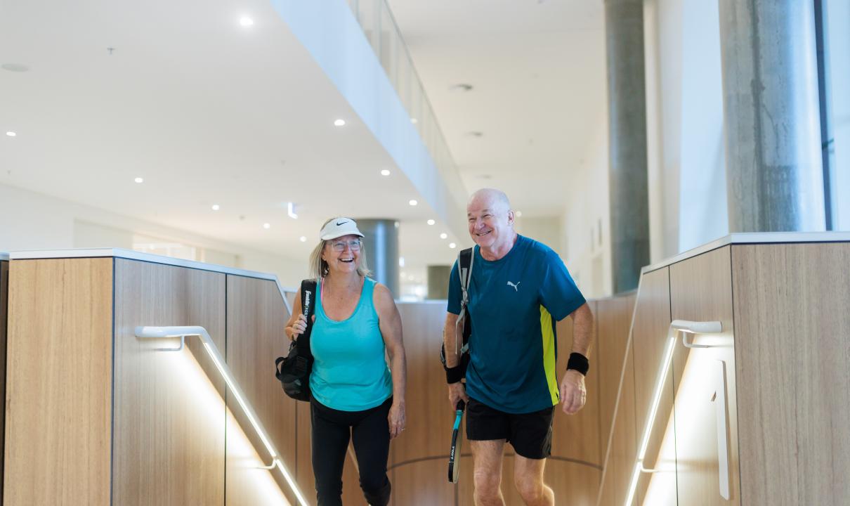 Two people walking up the stairs